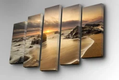 Lerretsbilde i 5 deler 82x50 cm - Solnedgang over en strand med steiner og rolige bølger
