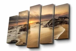 Lerretsbilde i 5 deler 82x50 cm - Solnedgang over en strand med steiner og rolige bølger